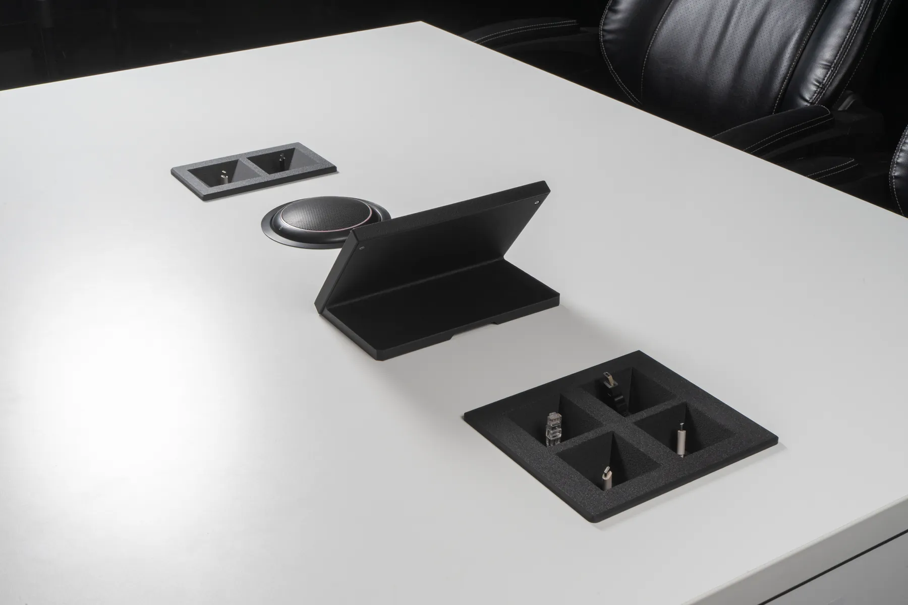 Charcoal Kubby Quatro in the foreground of a boardroom table with an iPad Mini Table Stand and Kubby Dos behind